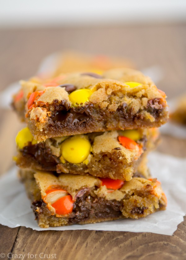 Brown Butter Blondies stacked on parchment paper and wood