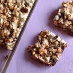 overhead shot of popcorn cereal treats on purple background