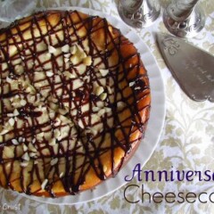 overhead ove cheesecake covered in chocolate and macadamia nuts on table cloth