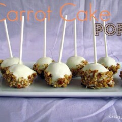 carrot cake pops covered in white chocolate and pecans with sticks sticking up on purple background