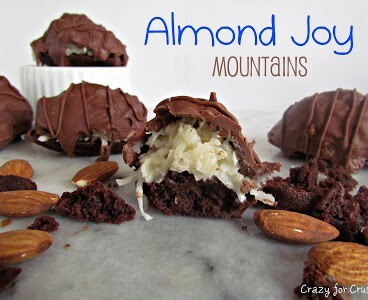 almond joy mountains - chocolate brownie bites with coconut topping and covered in chocolate on a marble slab with words on photo