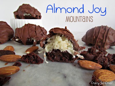 almond joy mountains - chocolate brownie bites with coconut topping and covered in chocolate on a marble slab with words on photo