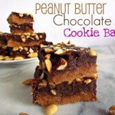 chocolate peanut butter cookie bars with peanuts on marble slab