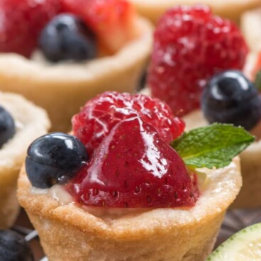 close up of mini fruit tart with berries