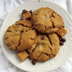 peanut butter caramel chocolate chip cookies on white plate