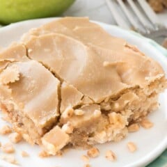 apple toffee bars on white plate with apple behind