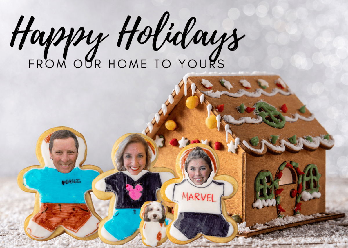 christmas card with sugar cookie people in front of a gingerbread house