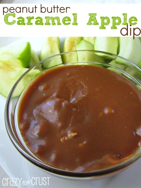 peanut butter caramel apple dip in a glass bowl with apples on white plate and title