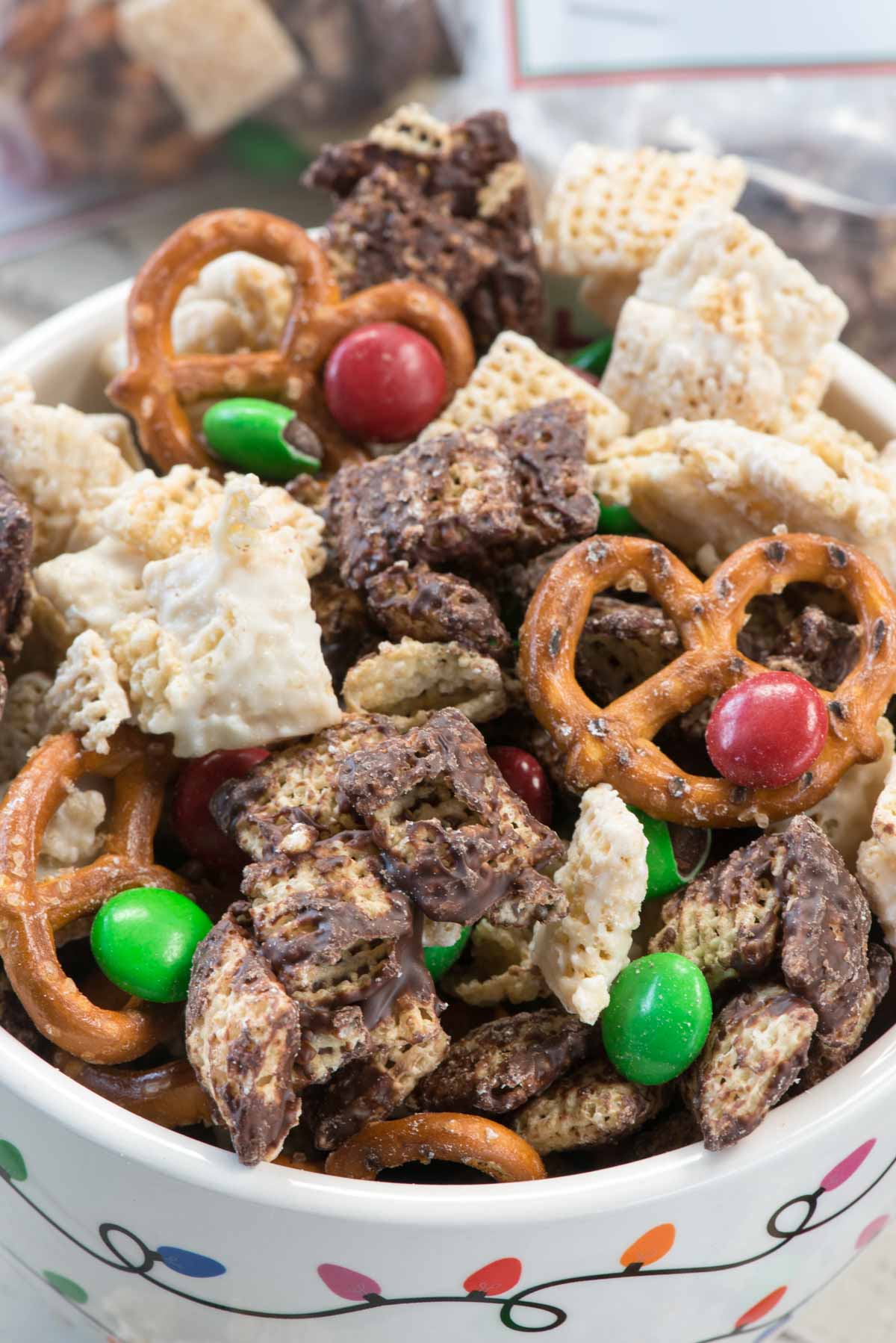 Elf Munch is the perfect Christmas snack mix! Chocolate coated Chex mixed with pretzels and candy are a great party treat for the kids especially with the FREE printable tags.
