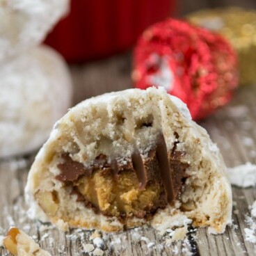 Reese's Stuffed Snowballs cookies with half a cookie to show the inside