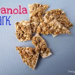 granola bark white chocolate with granola on top on blue paper with words