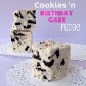 white chocolate fudge with chunks of oreos on white doily and purple background