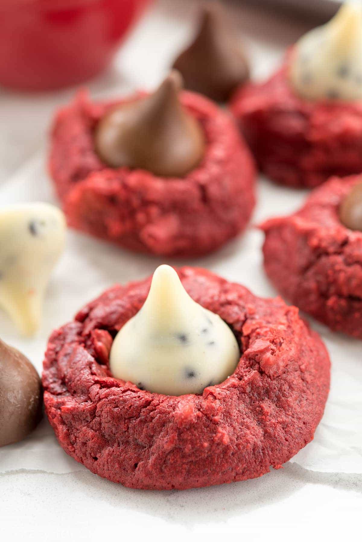 Red Velvet Hugs Blossom Cookies - this easy cookie recipe starts with a red velvet cake mix! Add a Hershey's Kiss and make them blossom cookies!