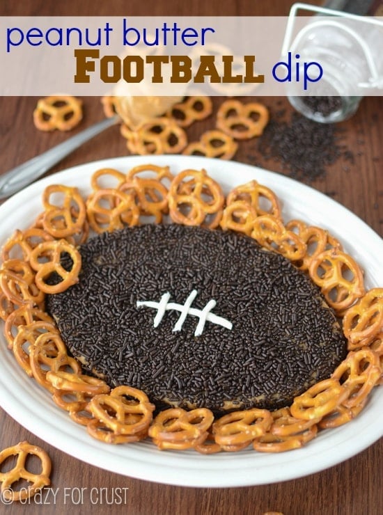 Peanut butter football dip on white plate with pretzels and title