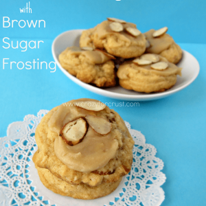 Almond Pudding Cookies with Brown Sugar Frosting on doily and white plate