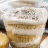 plastic cup with slices of cupcake layered with tiramisu filling