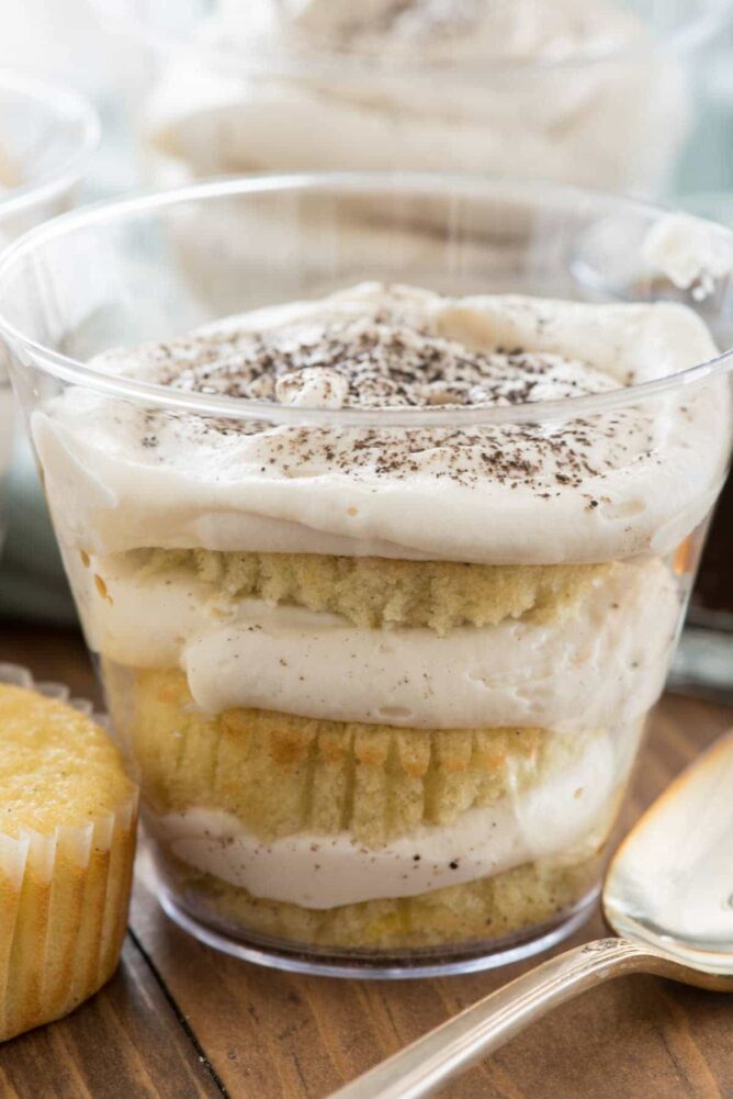 plastic cup with slices of cupcake layered with tiramisu filling
