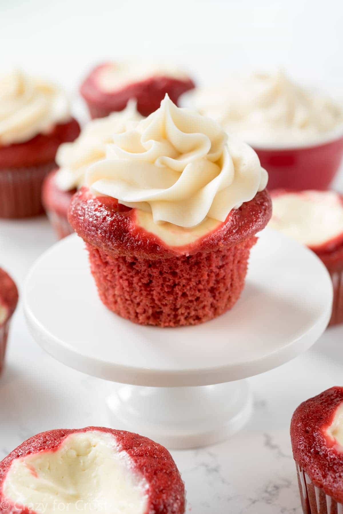 Red Velvet Cream Cheese Cupcakes - these easy cupcakes are completely from scratch. Red Velvet Cake filled with cheesecake and topped with cream cheese frosting - an amazing cupcake recipe!