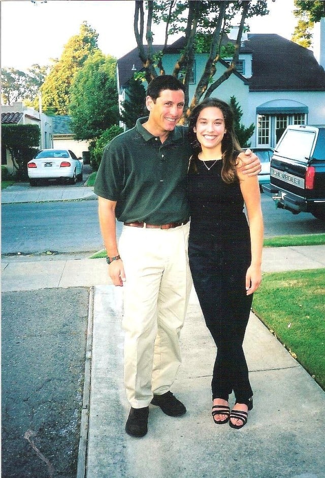 man and woman standing on driveway 