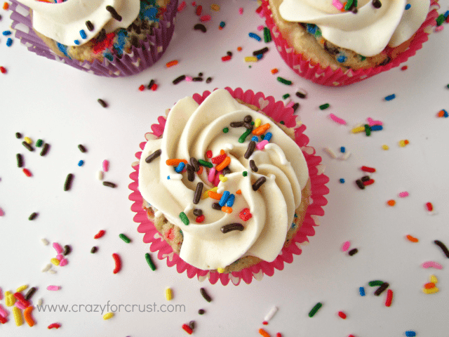 Overhead shot of funfetti cake batter pies on white counter with rainbow sprinkles everywhere