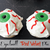 white, red and green eyeball pie laying on a spiderweb background with graphic title on the bottom