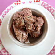 Overhead shot of french silk pie ice cream in a white bowl with pink background.