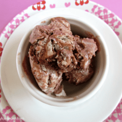 Overhead shot of french silk pie ice cream in a white bowl with pink background.