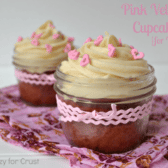 pink velvet cupcakes in jars with cream cheese frosting and pink heart sprinkles, wrapped with a pink bow with words on photo