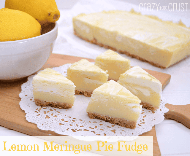 Lemon Meringue Pie Fudge cut into triangle slices and sitting on white doily and wooden cutting board