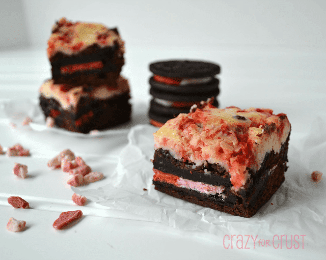 brownies with candy cane oreos and cheesecake on top on white background