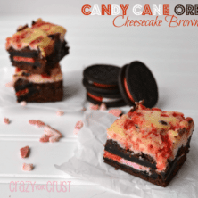 Candy Cane Oreo Cheesecake Brownies with candy cane oreos on a white table, with graphic image at the top right.