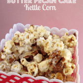Red and white container of butter pecan cake kettle corn, with graphic title on the top.