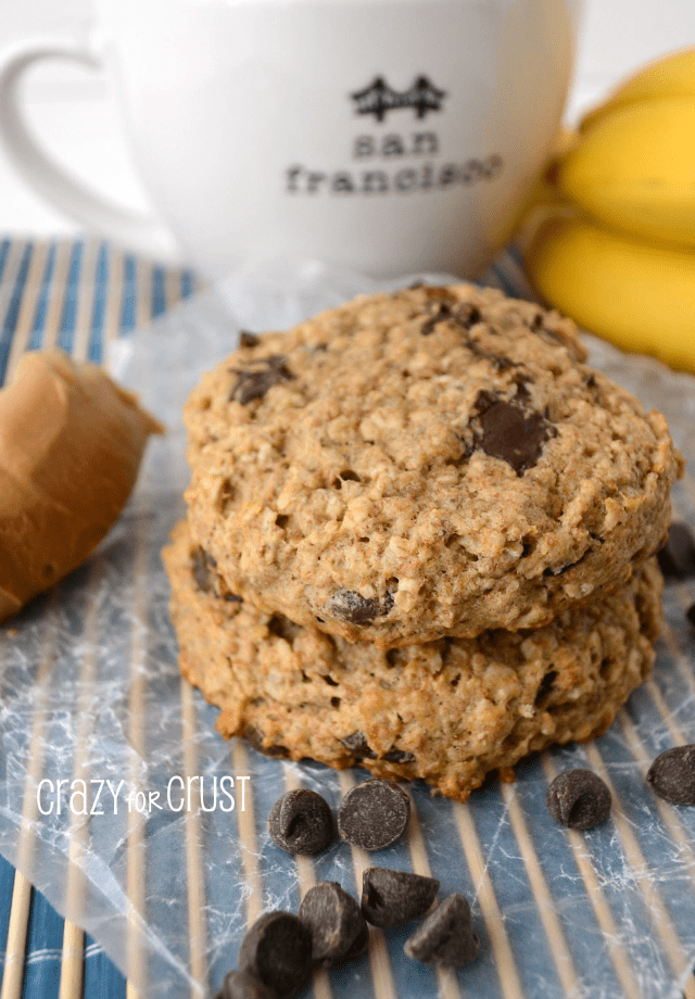 Oatmeal breakfast cookie stack on parchment paper with coffee cup