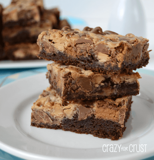 Stack of three Brownie Peanut Butter Magic Bars on a white plate