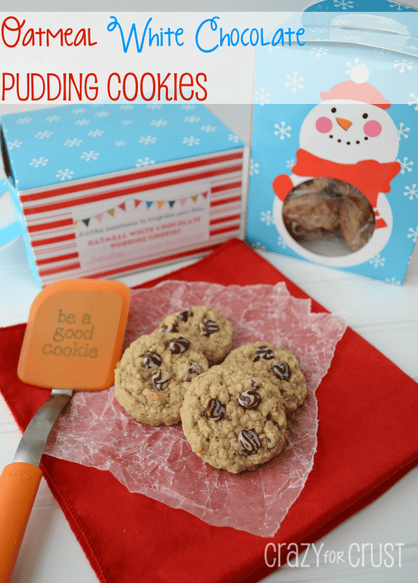 oatmeal white chocolate pudding cookies on wax paper on red napkin with spatula and other items