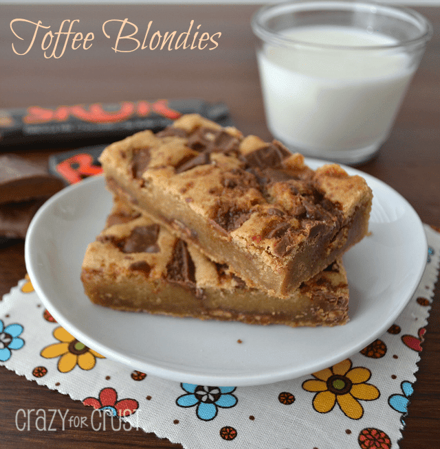 A plate of toffee blondies on a white plate on a flower napkin.