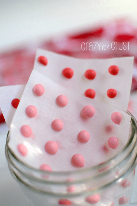 candy buttons on parchment in jar