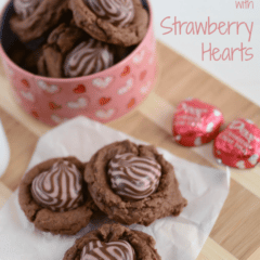 Nutella Chocolate Pudding Cookies with heart chocolate in center on parchment and cutting board