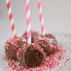Truffle Stuffed Brownie Pops on platter with pink and red straws and sprinkles