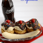 banana split cupcakes in ice cream dish decorated like a sundae with a banana and a coke bottle