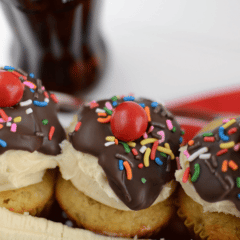banana split cupcakes in ice cream dish decorated like a sundae with a banana