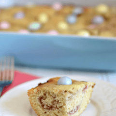 raspberry snack cake slice on white plate and in pan