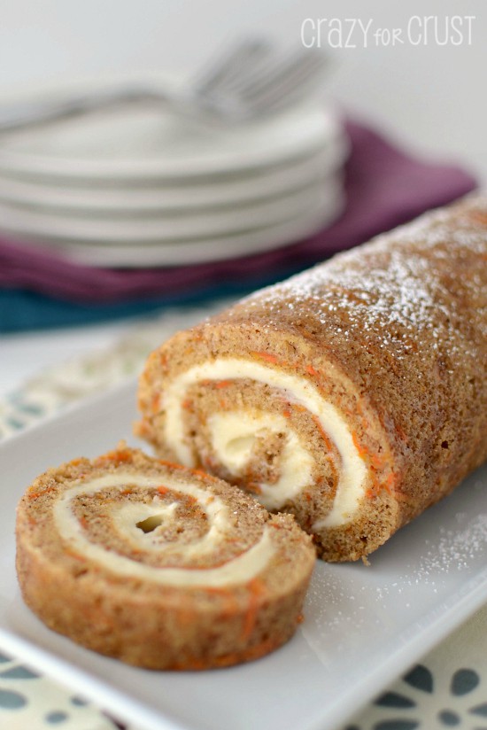 carrot cake roll sliced on white platter