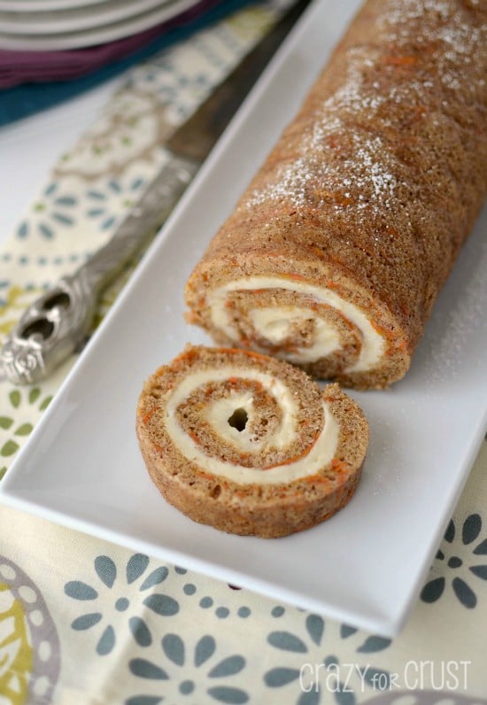 carrot cake roll sliced on white platter