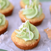 coconut cookie cups with lime buttercream on parchment paper with words