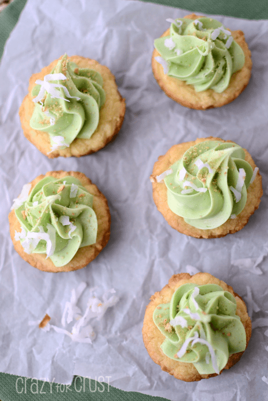 coconut cookie cups with lime buttercream on parchment paper