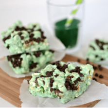 mint chocolate popcorn treats on parchment on cutting board