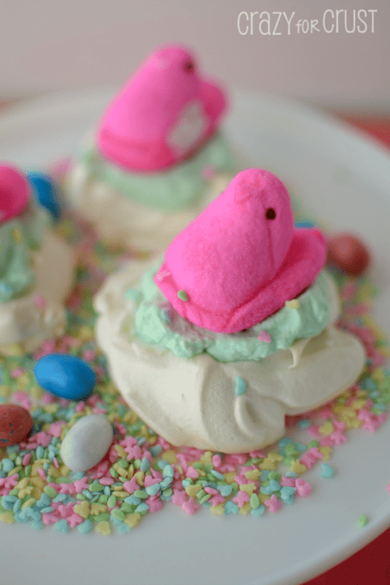 peeps nests meringue cookies with peep on top on white cake platter