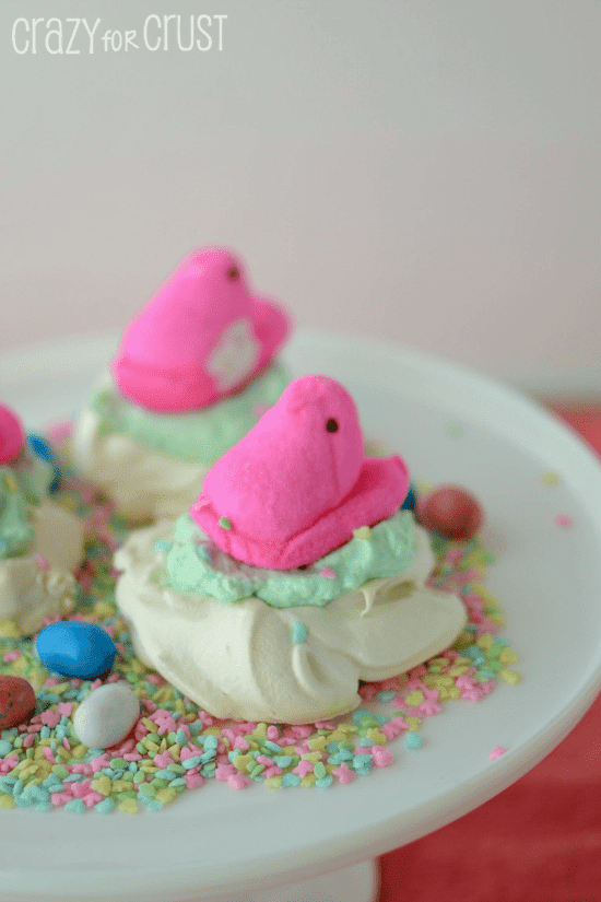 peeps nests meringue cookies with peep on top on white cake platter