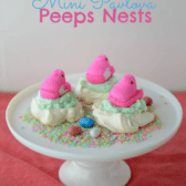 peeps nests meringue cookies with peep on top on white cake platter